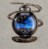 BKB Custom Gifts blue ornate pocket watch with a celestial dial, Roman numerals, and a metallic alloy chain.