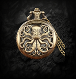 BKB Custom Gifts antique bronze octopus pocket watch with intricate metal tentacles on a dark draped fabric background