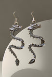BKB Custom Gifts silver-toned stainless steel dragon dangle earrings with intricate scales and secure hook backs.